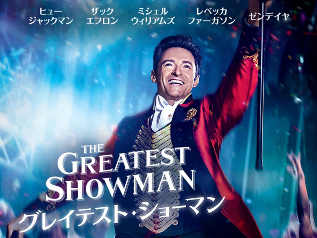 ヒュー・ジャックマン主演のミュージカル映画「グレイテスト・ショーマン」の日本版ポスター。燕尾服姿の主人公が手を広げて微笑んでいる様子。